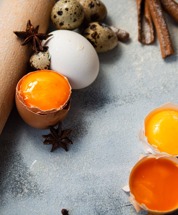 Kontakt oss Fresh egg yolks and baking ingredients arranged for food photography. Ideal for culinary themes.