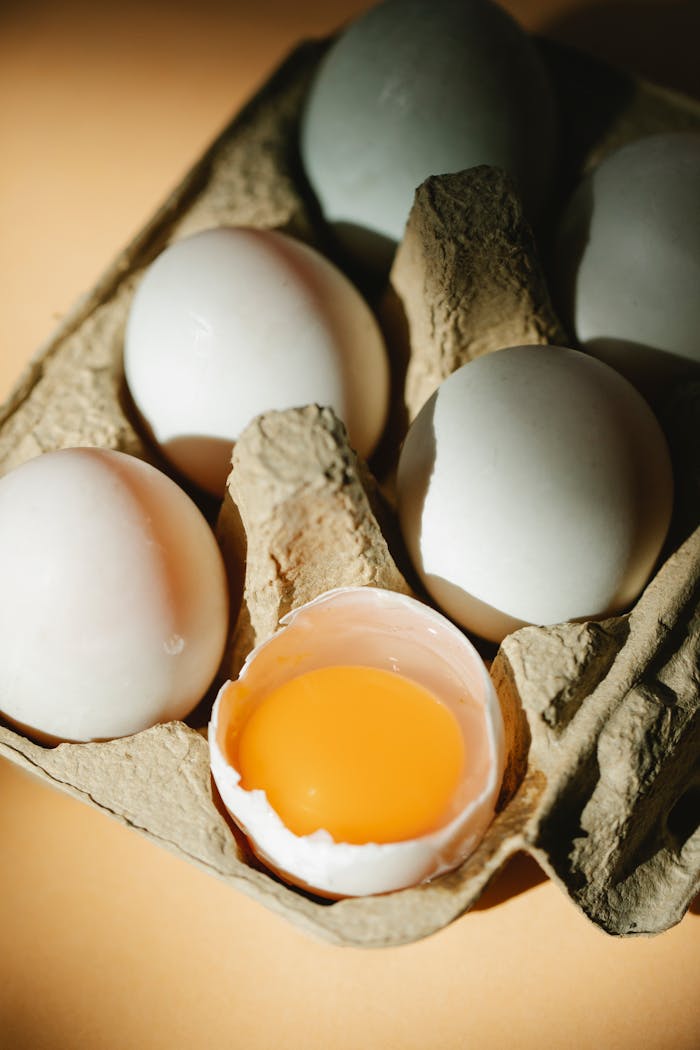 The Art of Drawing Readers In: Your attractive post title goes here From above of whole and broken white raw chicken eggs with bright yolk placed in carton container